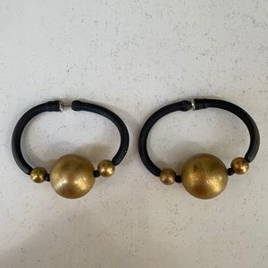 Earrings. Are of black rubber w/gold beads
